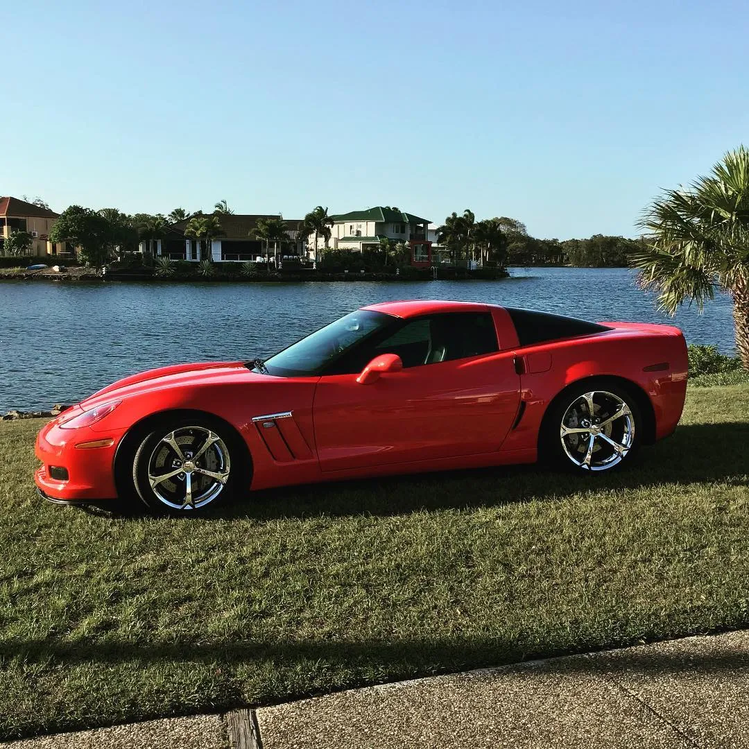 Red Corvette Grand Sport after a detail, parked by the water