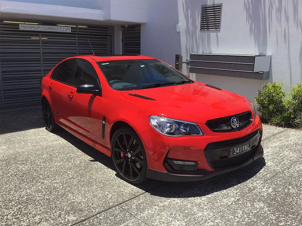 Red Holden Commodore after an exterior detail