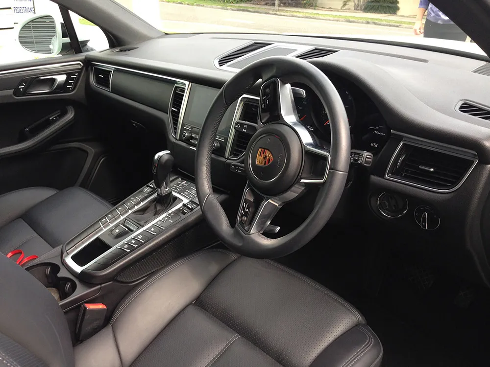 Detailed Porsche interior with clean leather seats and dashboard